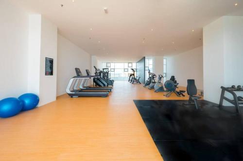 a gym with several treadmills and exercise bikes at JOVIAL Modern Cozy Suite `Metropol BM BandarPerda in Bukit Mertajam