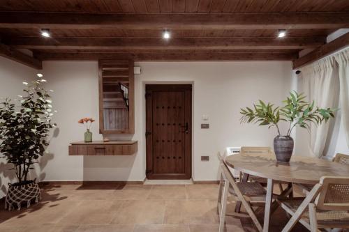 a dining room with a table and chairs at Villa Frontale - Restored Villa with Pool Perfect for 4 Nestled Next to a Traditional Olive Mill and Local Farms Offering Authentic Hospitality and Organic Delights By Villa Mana Gers in Kallithea