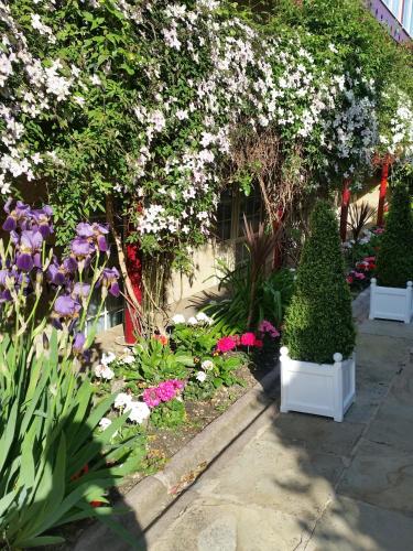 a garden with flowers and plants in front of a building at Garrison Hotel in Sheffield