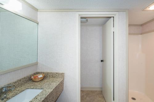 a bathroom with a sink and a mirror at Mountainside Inn 107 by Alpine Lodging Telluride in Telluride