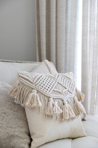 a white pillow sitting on top of a couch at 't Hooiland in Lo-Reninge