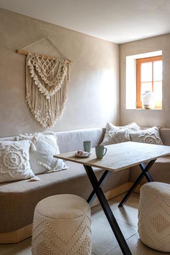 a living room with a couch and a table at 't Hooiland in Lo-Reninge