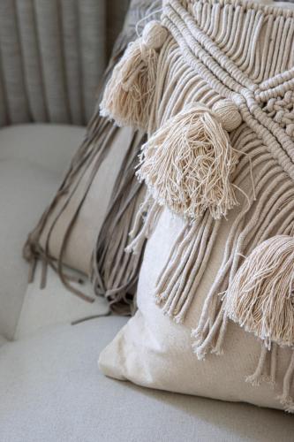 a pile of pillows sitting on top of a bed at 't Hooiland in Lo-Reninge