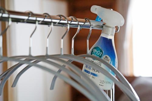 a rack with a toothbrush and a bottle of tooth paste at The LODGE ABASHIRI in Abashiri
