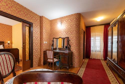 a room with a vanity and a mirror and a chair at Heritage Hotel Pasike in Trogir