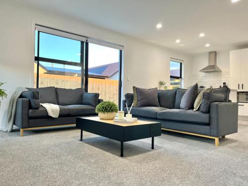 a living room with two couches and a coffee table at Brand New & Ready for You! By KOSH BNB in Hamilton