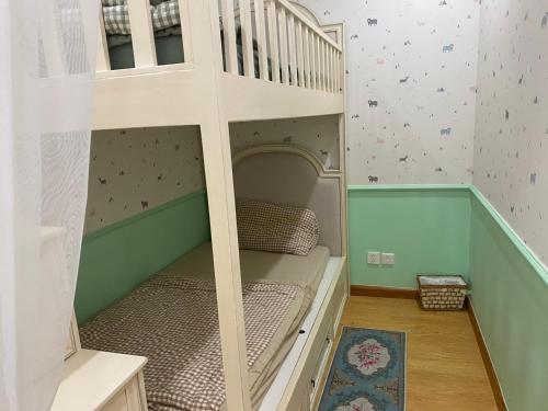 a bunk bed in a childs room with a staircase at Princess Vinhomes Smart City Apartment in Hanoi