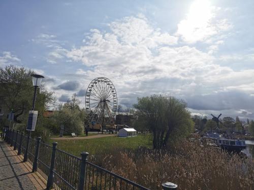 a ferris wheel in a park under a cloudy sky at Quitte10 in Glindow
