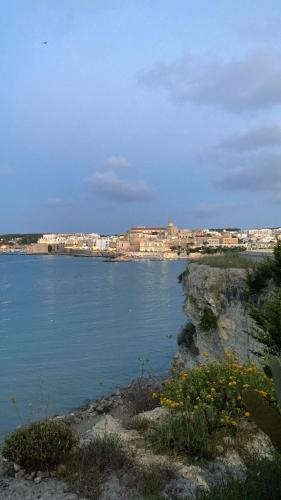 a large body of water with buildings in the background at A Casa di Lu in Minervino di Lecce