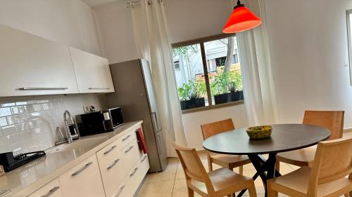 a kitchen with a table and chairs in a kitchen at Roza Apartment in Tel Aviv