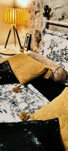 a bedroom with two beds and a table with a lamp at Campagne et Mer in Saint-André-de-Lidon