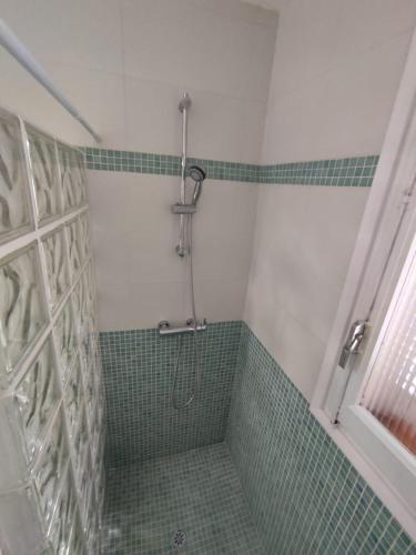 a bathroom with a shower with green tile at VILLA MARIBEL in Calafat