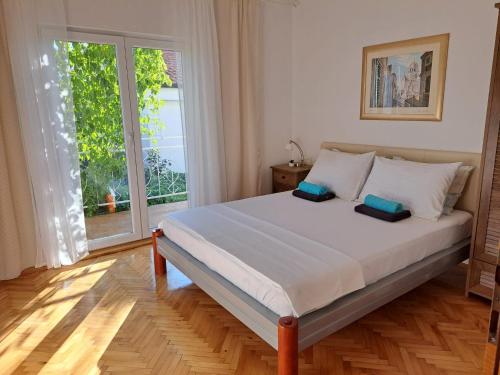 a bedroom with a bed with two pillows on it at Apartments Ana Žaborić, 50 m od šljunčane plaže in Zaboric