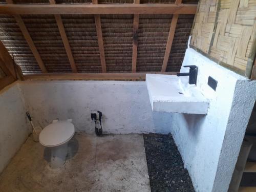 a bathroom with a toilet and a sink at Apache surf villa in San Isidro