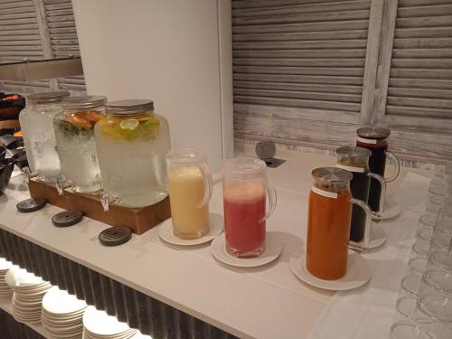 a group of different types of drinks on a counter at Hotel Tahití Playa in Santa Susanna