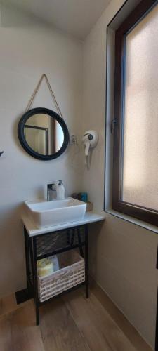 a bathroom with a sink and a mirror on the wall at Atonika Apartments Bitola in Bitola
