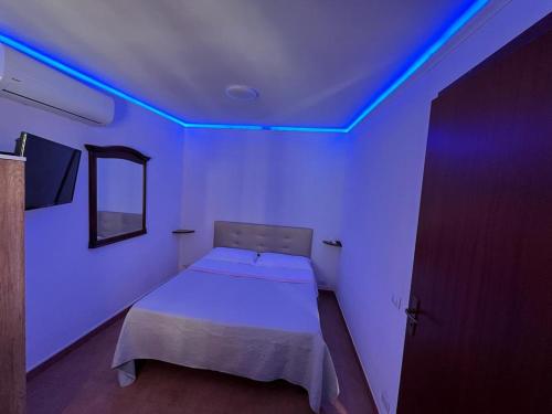 a bedroom with a bed with blue lights on it at Villa Grazia in Capo Vaticano