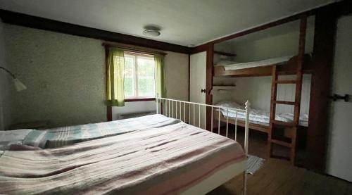 a bedroom with two bunk beds and a window at STF Tivedstorp in Tivedstorp