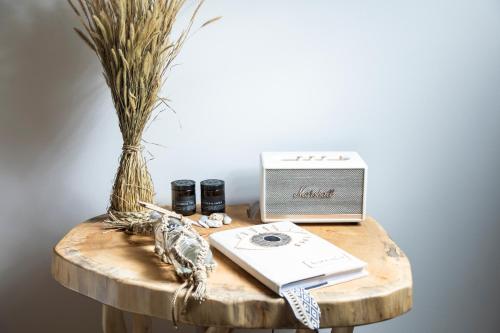 a table with a laptop and a book on it at Bohemia Luxury Living in Hanioti
