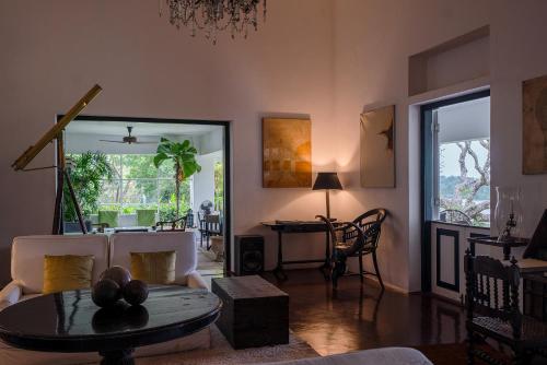 a living room with a couch and a table at Lunuganga Estate in Bentota