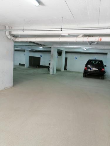 a parking garage with a car parked in it at City Center Condo Vranje in Vranje