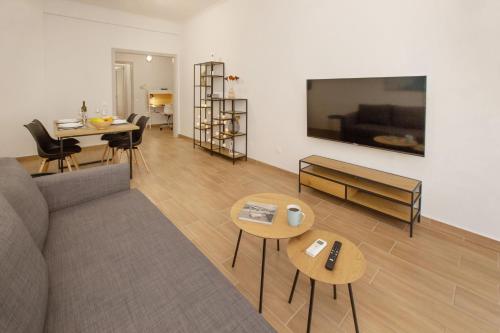 a living room with a couch and a table at Beautiful apt near the sea by GHH in Athens