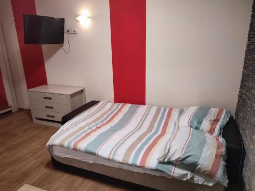 a bedroom with a bed and a tv on a wall at Apartment in the center of Krakow in Kraków