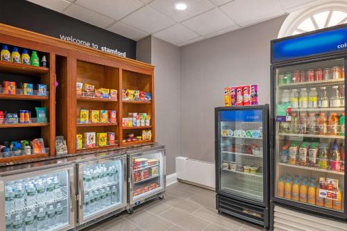 a grocery store aisle with a drink refrigerator at Hampton Inn & Suites Stamford in Stamford