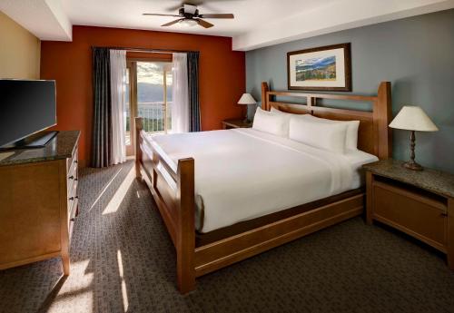 a bedroom with a large bed and a television at Spirit Ridge, in The Unbound Collection by Hyatt in Osoyoos