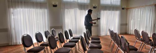 a man standing in a room with rows of chairs at Spirit Ridge, in The Unbound Collection by Hyatt in Osoyoos