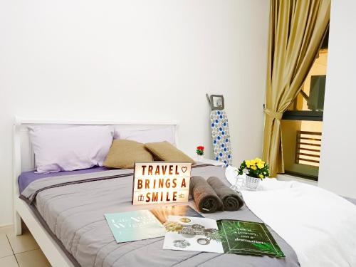 a bedroom with a bed with a sign on it at Medini Elysia Park , 3 min to Legoland, Netflix By Hint Homestay in Nusajaya
