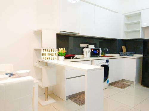 a kitchen with white cabinets and a white counter top at Medini Elysia Park , 3 min to Legoland, Netflix By Hint Homestay in Nusajaya