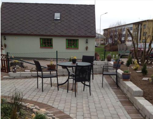 a patio with a table and chairs in front of a house at Vivans Bed and Self catering in Kristianstad