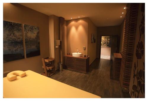 a bedroom with a bed and a bathroom with a sink at Aparthotel Regina Mare in Tsarevo