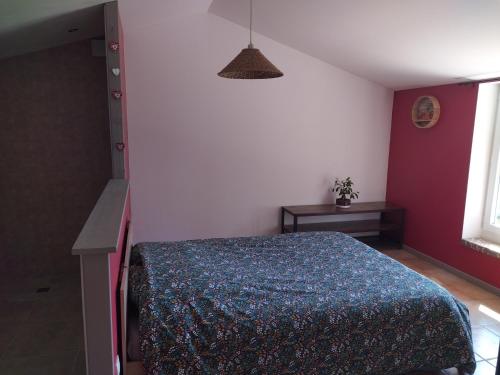 a bedroom with a bed with a blue blanket at La Coste Blanque in Montaut
