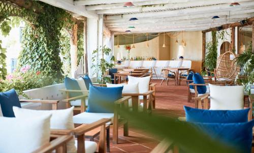 a restaurant with chairs and tables and plants at Approdo Resort Thalasso Spa in Castellabate