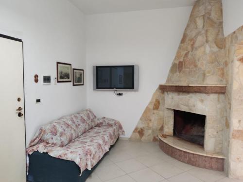 - un salon avec un canapé et une cheminée dans l'établissement Villa Borraco - 800m from the SEA, à San Pietro in Bevagna