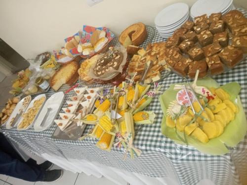 a table topped with lots of different types of food at Hotel Recanto Vip in Araripina