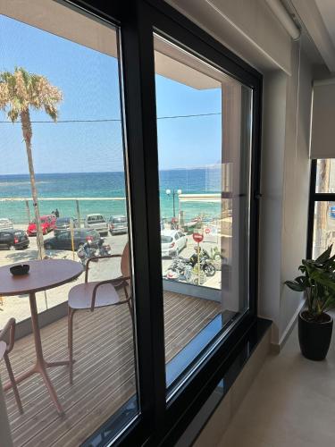 a room with a balcony with a view of the ocean at Theta Boutique Hotel in Chania