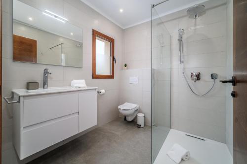 y baño con ducha, lavabo y aseo. en Villa La Sella by Rock Rentals, en Pedreguer