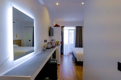a hotel room with a bed and a mirror at Vila Enxhi in Ksamil
