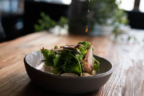 a plate of food on a wooden table at Petra & Fos Boutique Hotel & Spa in Neon Oitilon