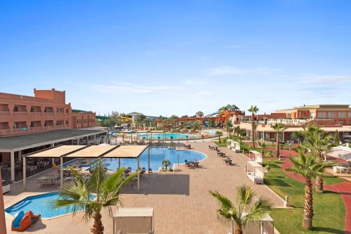 a view of a resort with a pool and palm trees at Pickalbatros Aqua Fun Club All Inclusive in Marrakech