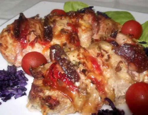 two slices of pizza on a plate with tomatoes at Hotel Bucegi Portile Regatului in Paraul Rece