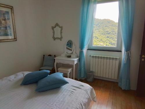 a bedroom with a bed and a sink and a mirror at ANITA B&B in Uscio