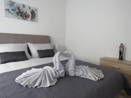 a towel sculpture of swans sitting on a bed at Erika Medulin in Medulin