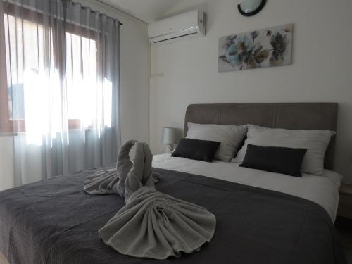 a bedroom with a large bed with a towel on it at Erika Medulin in Medulin