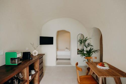 a living room with a table and a dining room at Villa Patitiri cave house with private pool in Megalochori Santorini in Megalokhori
