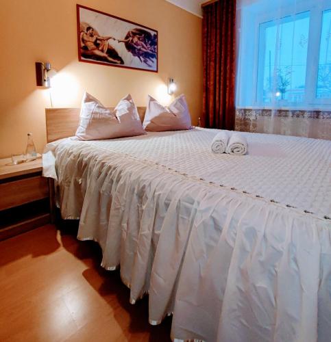 a bedroom with a large bed with two towels on it at Perfect flat city centre in Sigulda