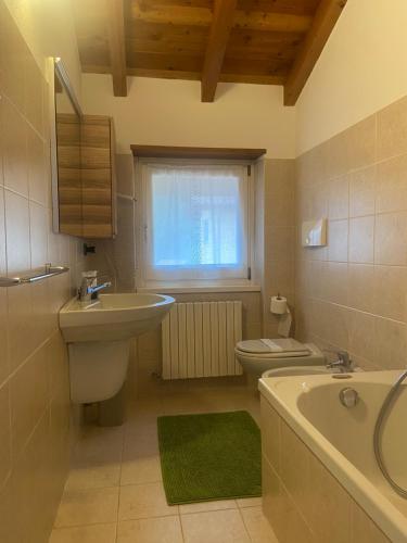 ein Badezimmer mit einem Waschbecken, einem WC und einer Badewanne in der Unterkunft Casa Camilla in Colico
